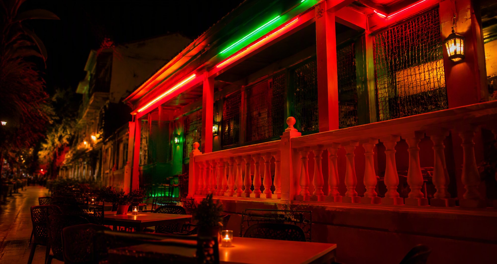 Food Karma terrace at night under the neon sign